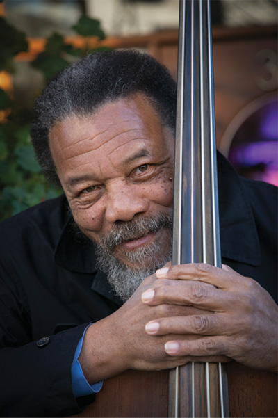 Dewayne Oakley and his bass violin, with the smile of a satisfied musician.